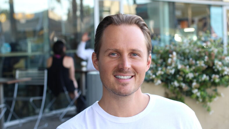 Young handsome man smiling at a restaurant.