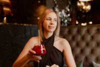 Charming young woman in evening dress dreamily