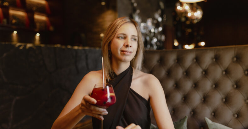 Charming young woman in evening dress dreamily