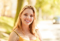 Happy smiling young woman outdoor. Pretty attractive