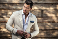 Portrait of young beautiful fashionable man against
