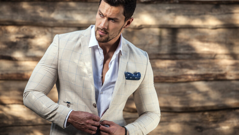 Portrait of young beautiful fashionable man against