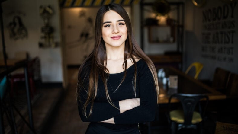 Beautiful young woman in cafe shop. Indoors