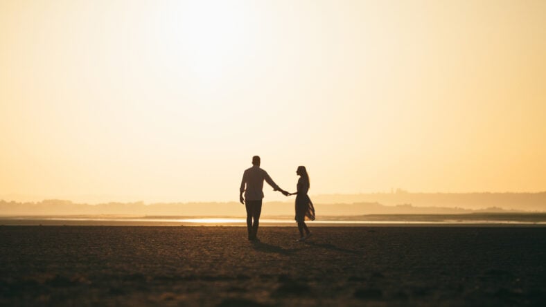 Couple in love walking on the beach