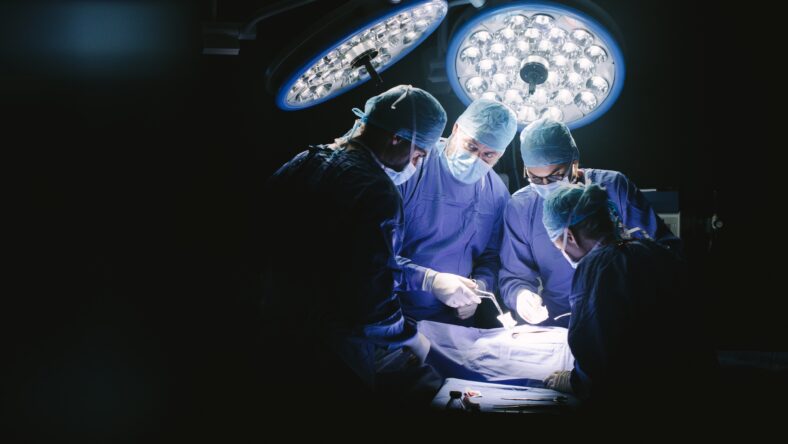 Group of surgeons in hospital operating theater.