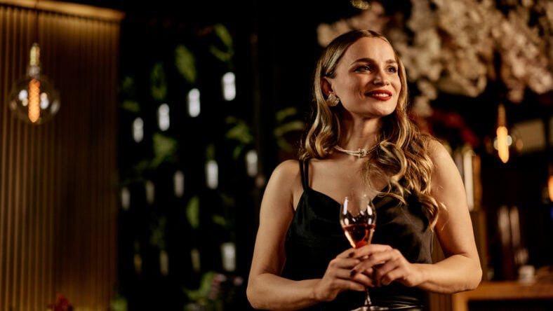Elegant woman holding a wine glass in