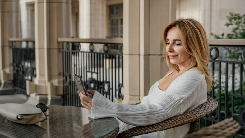 A woman in a white sweater sits