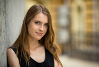 Attractive young girl standing oitdoors. View of