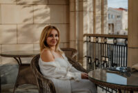 A woman in a white robe sits