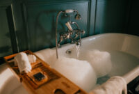 Luxurious clawfoot bathtub filled with bubbly water,