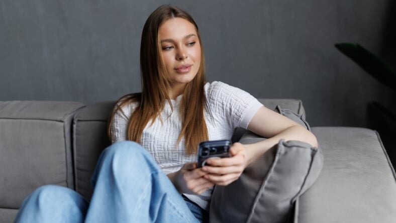 Smiling young lady chatting in social networks,