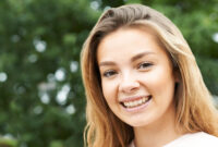 Head And Shoulders Portrait Of Smiling Teenage