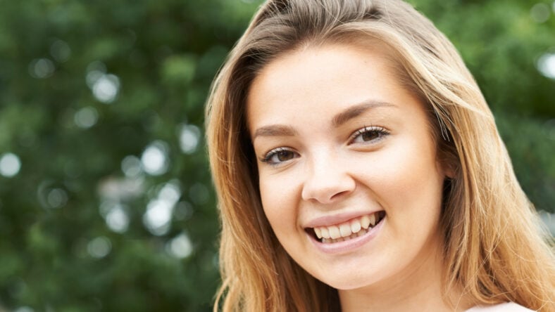 Head And Shoulders Portrait Of Smiling Teenage