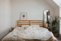Modern Bedroom With Unmade Bed And Natural