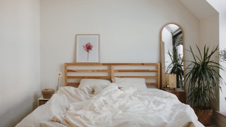 Modern Bedroom With Unmade Bed And Natural