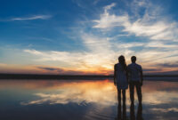 Portrait, silhouette of happy couple watching the