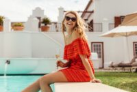 Smiling woman sitting on the pool edge
