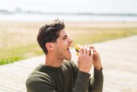 Young caucasian man at outdoors holding a