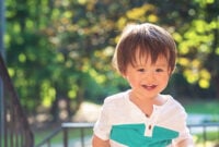 Happy toddler boy playing outside on a