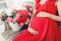Beautiful pregnant woman touching her belly with