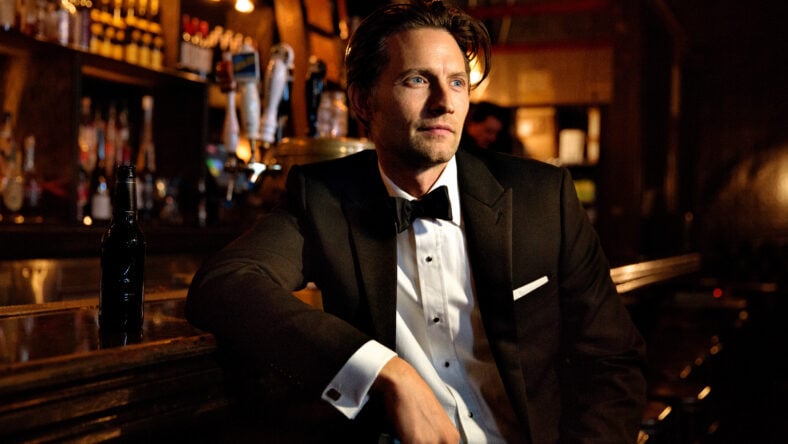 Man looking away while sitting at bar