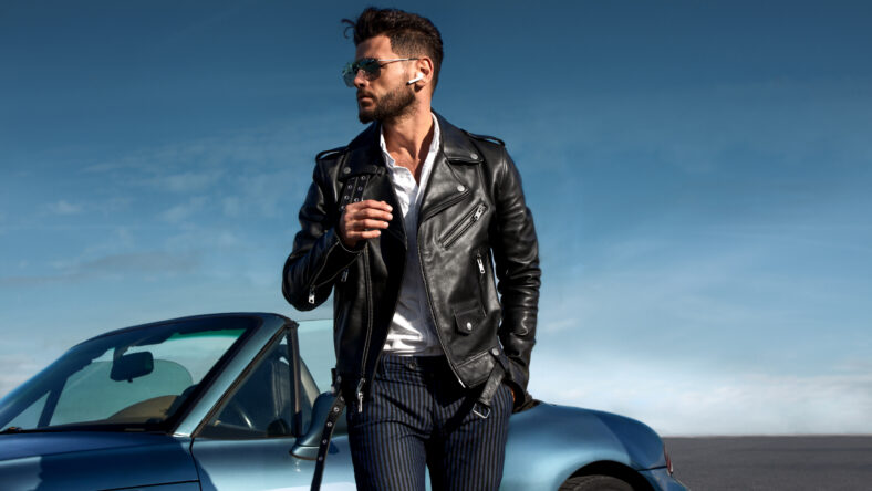 Successful, handsome man near the car.