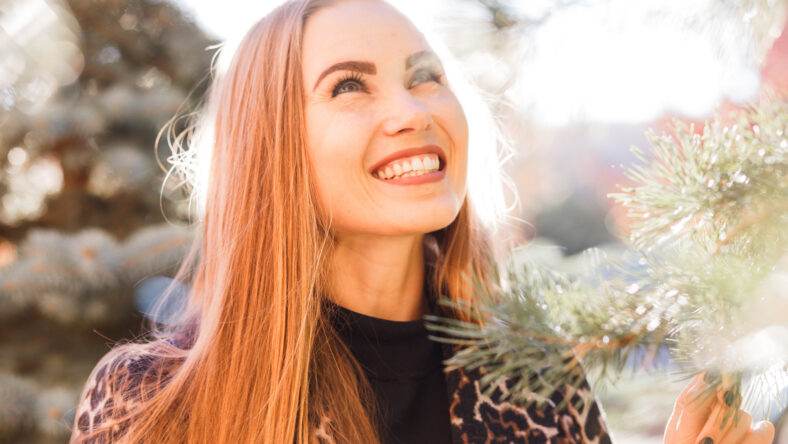 Beautiful stylish woman in the street smiling in sunshine light