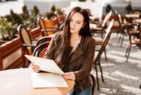 Beautiful brunette girl in a French cafe