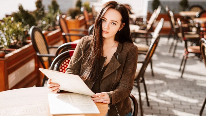 Beautiful brunette girl in a French cafe