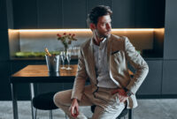 Handsome stylish man in beige suit at