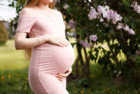 pregnant blonde girl in pink dress with