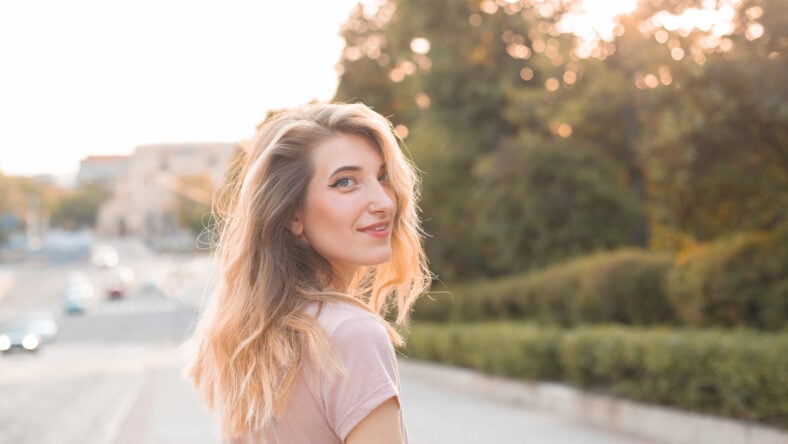 Beautiful young woman walking in the city.