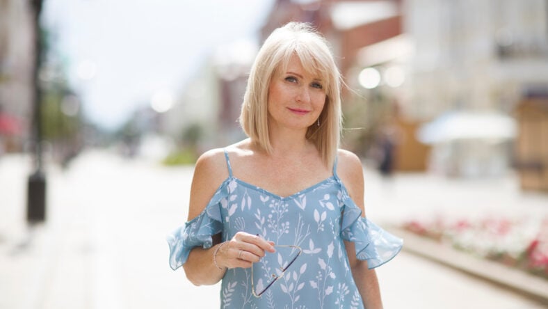 pretty blonde woman walking on the street