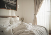 White interior of cozy bedroom with morning