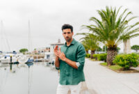 Attractive young man standing on the seafront