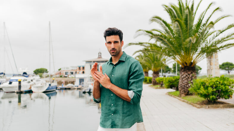 Attractive young man standing on the seafront