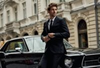 Young handsome man with black classic car