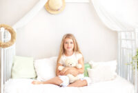 Childhood concept. Child playing in bed in