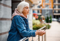 Calm mature woman is relaxing outdoors while