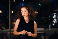 Pensive girl thoughtfully looking in camera waiting