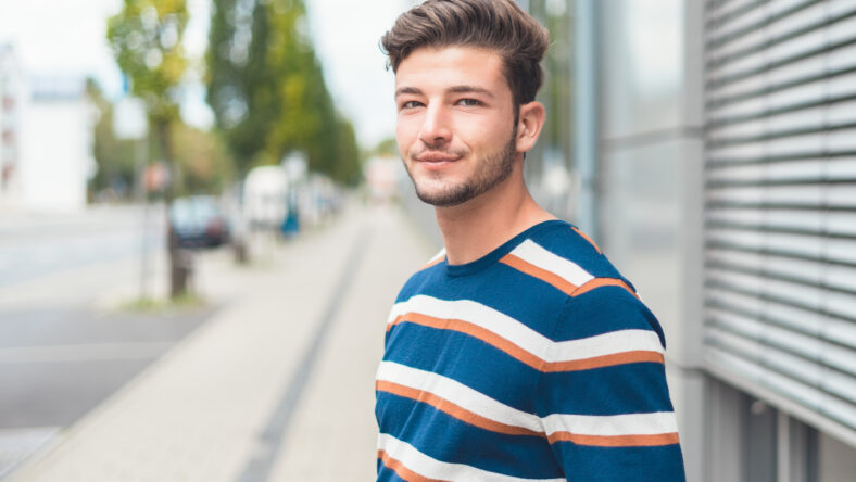 Portrait of young casual friendly man, selective