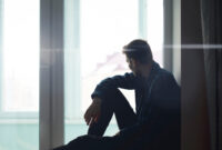 sad lonely thoughtful man silhouette sitting on