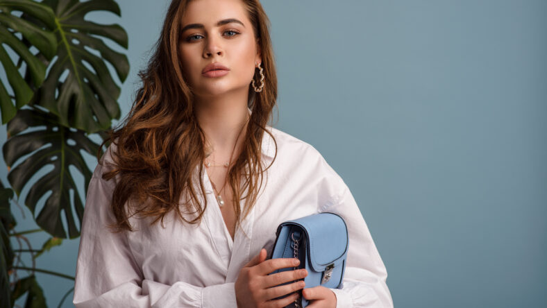 Fashionable woman wearing trendy white shirt, accessories,