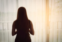 Back view of woman standing beside the