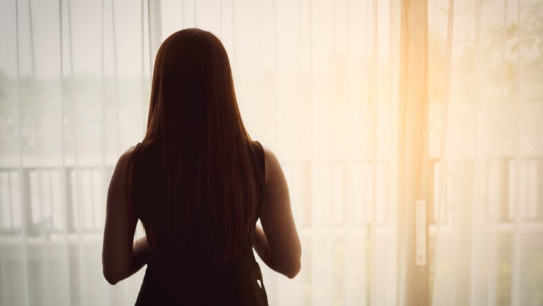 Back view of woman standing beside the