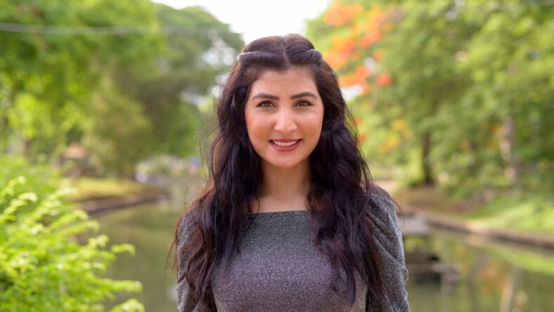 Portrait of young beautiful Indian woman relaxing