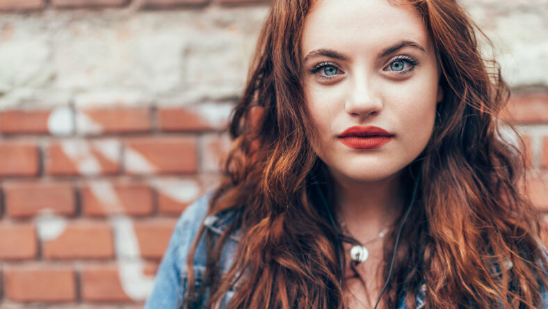 Fashion portrait of red curled long hair