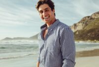 Handsome man smiling on the beach on