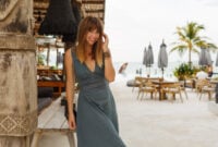 Happy brunette female in dress posing in