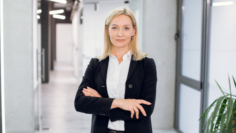 Indoor office portrait of pretty mature blond